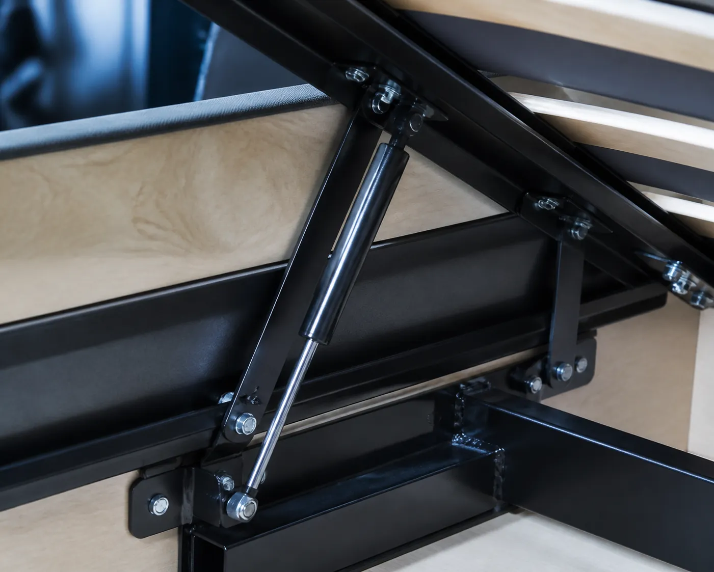 Close view of a hydraulic bed hinge and gas strut