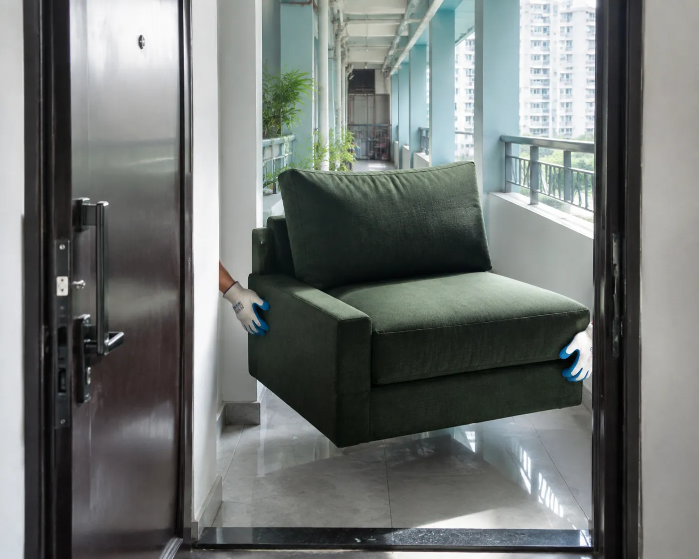 Green sofa module moving through a Mumbai apartment doorway