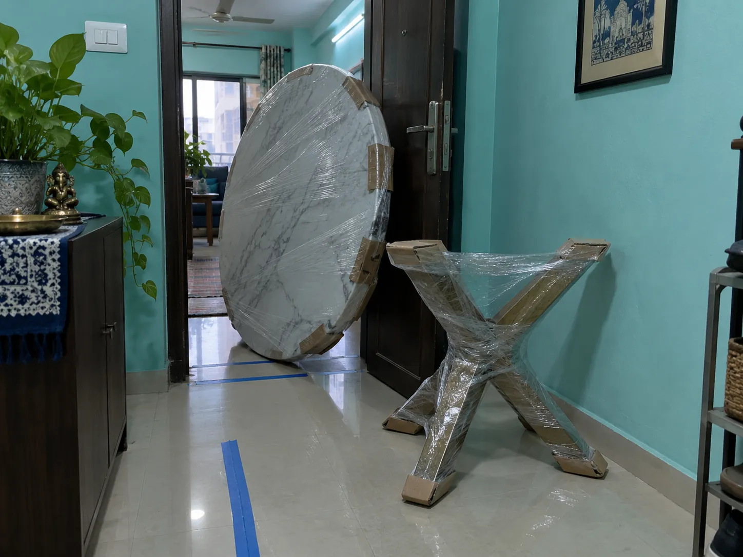 Wrapped coffee table components at a Mumbai apartment doorway